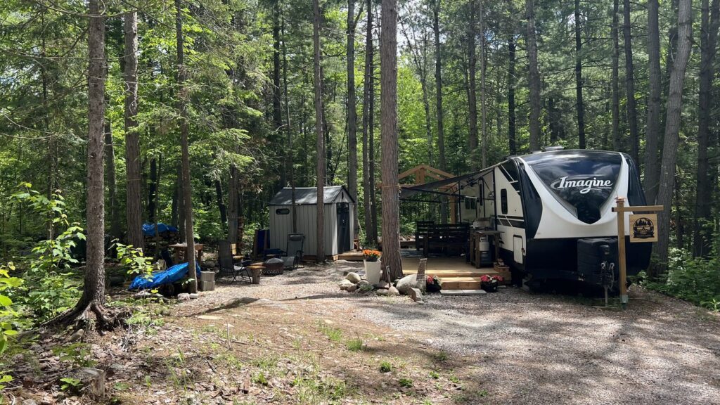Seasonal campsite with trailer at Noelville Family Resort